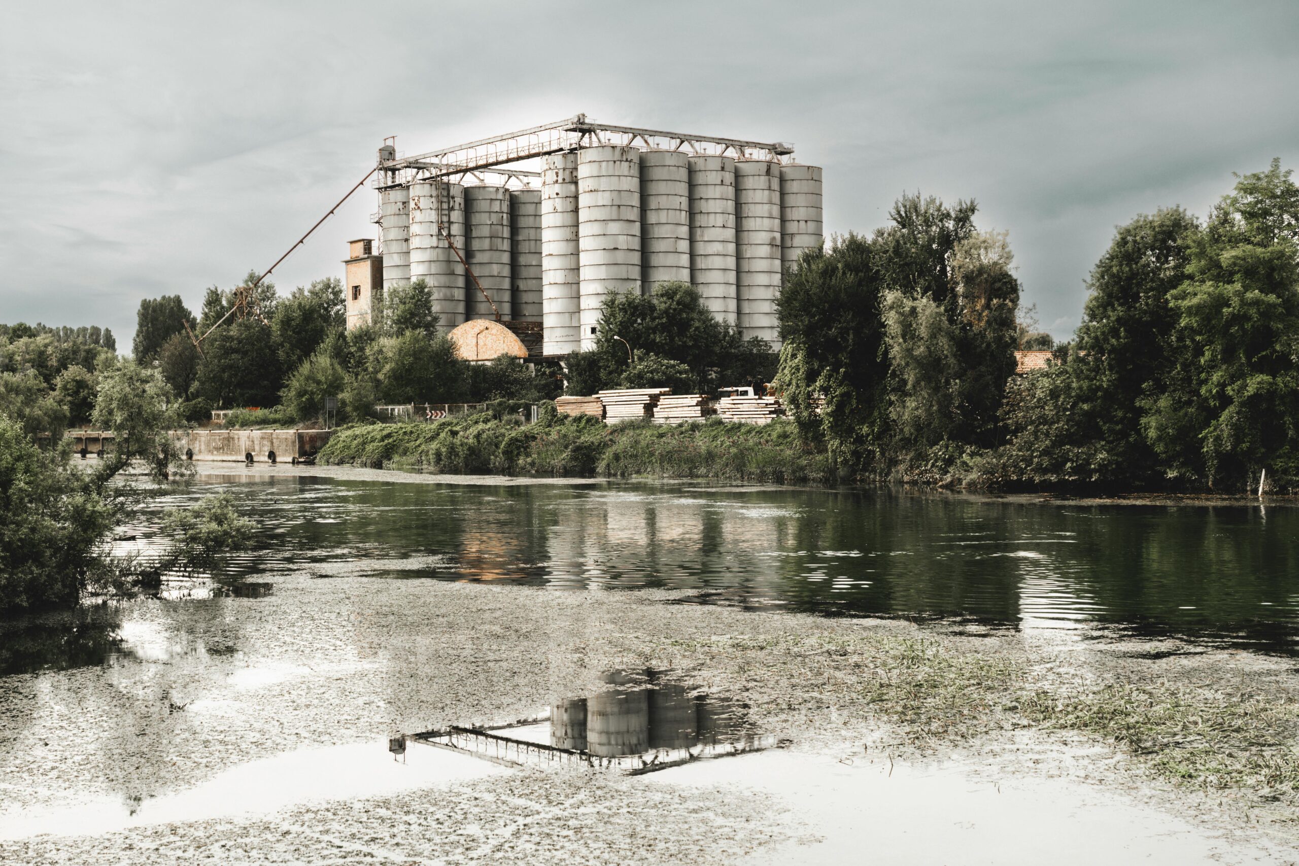 A large industrial spill causing environmental harm near a riverbank