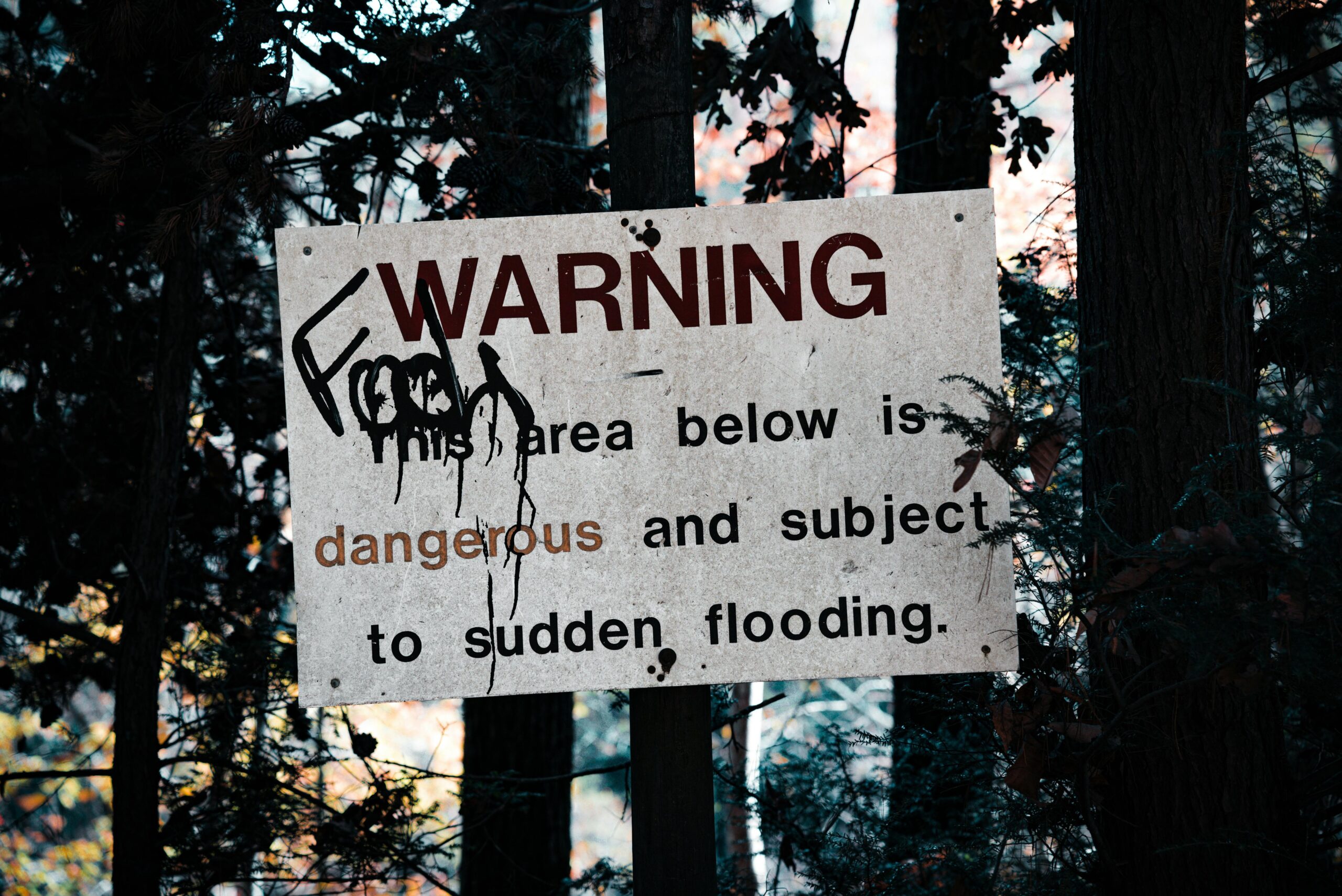 Photo of environmental hazard warning signs near a polluted area