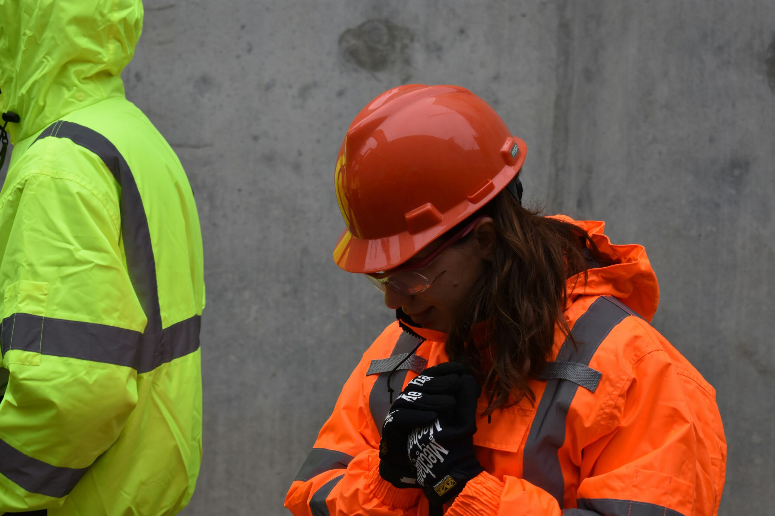 Crew wearing protective gear cleaning up hazardous materials from a site.