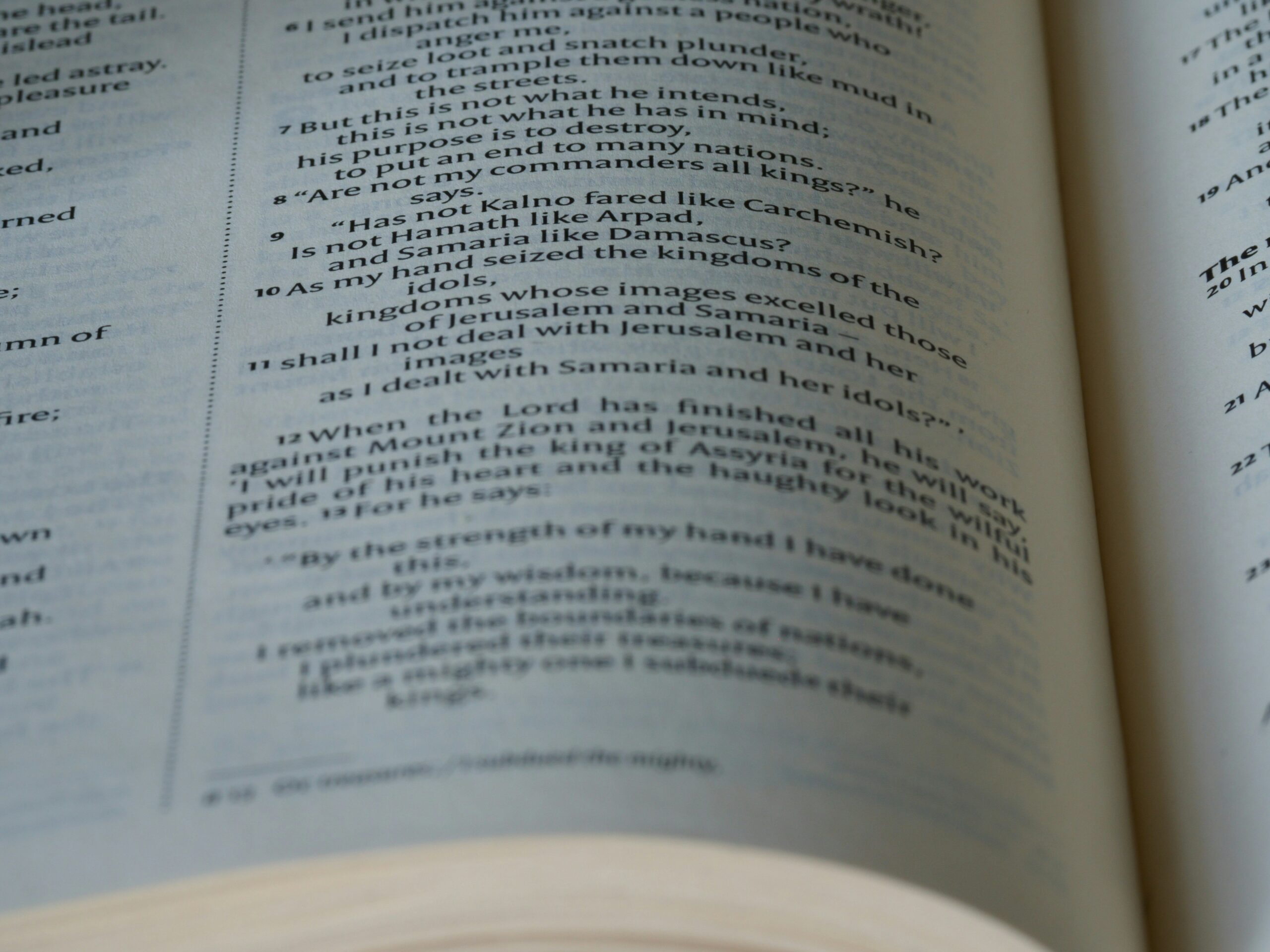 Closeup of hands reviewing detailed insurance contract with magnifying glass