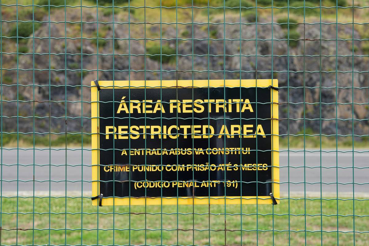 A polluted industrial site with workers wearing protective gear conducting cleanup operations