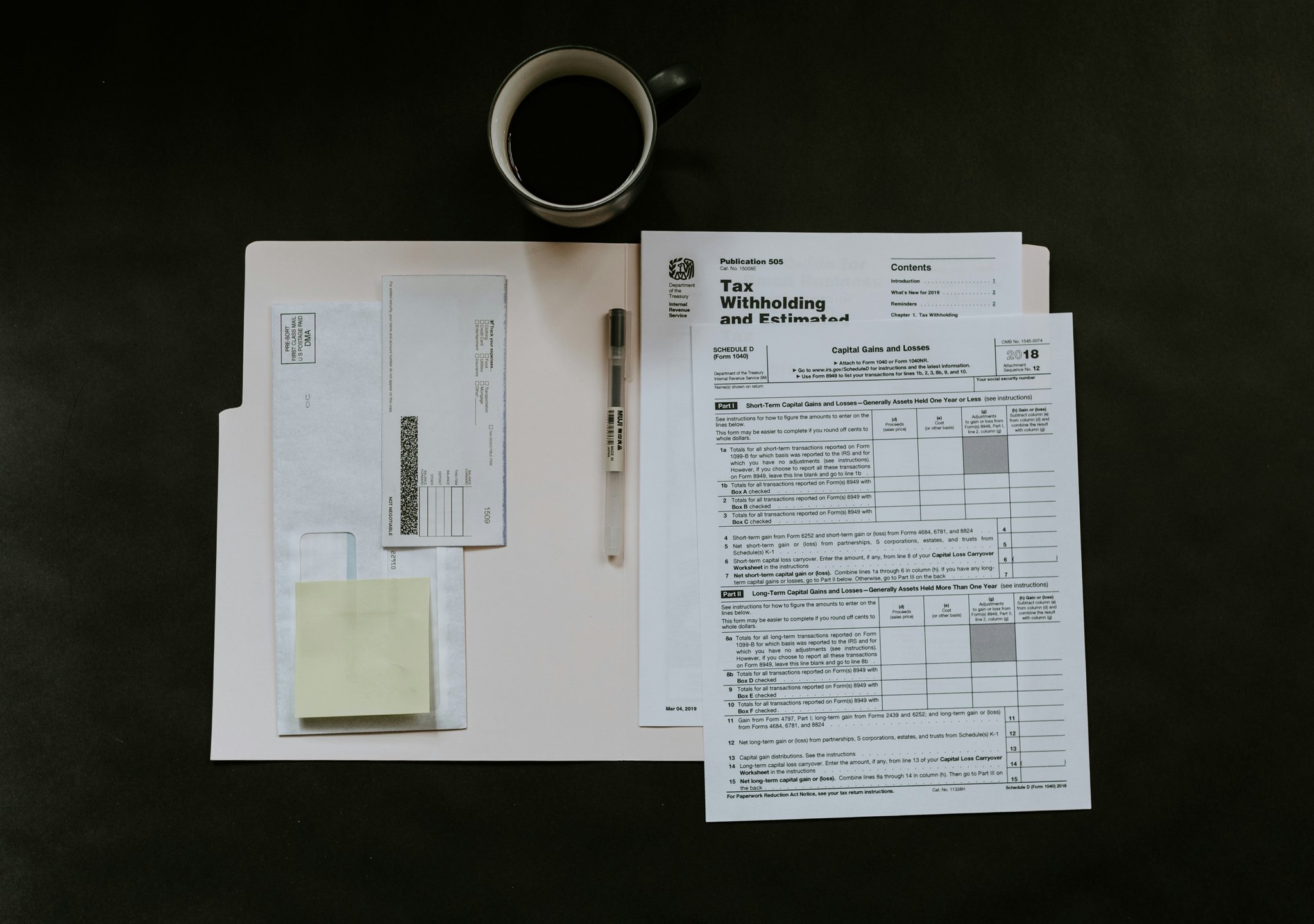 Pollution insurance policy document on a table with a pen and calculator