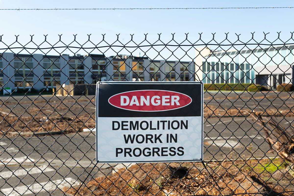 A team wearing hazmat suits conducting environmental cleanup at a polluted industrial site.