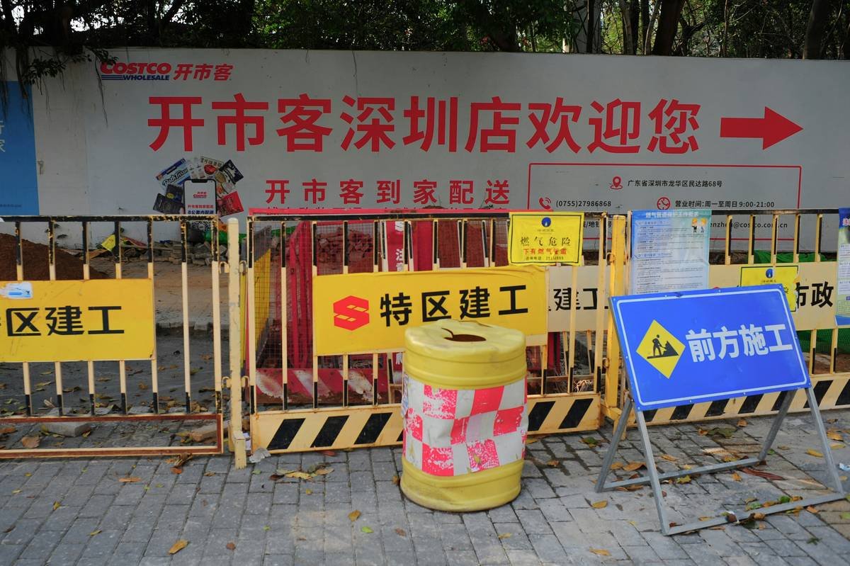 A worker wearing protective gear cleaning up toxic waste.