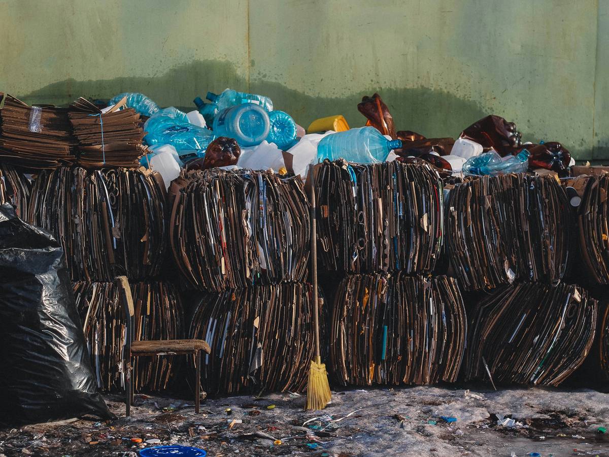 a pile of trash sitting next to a green wall