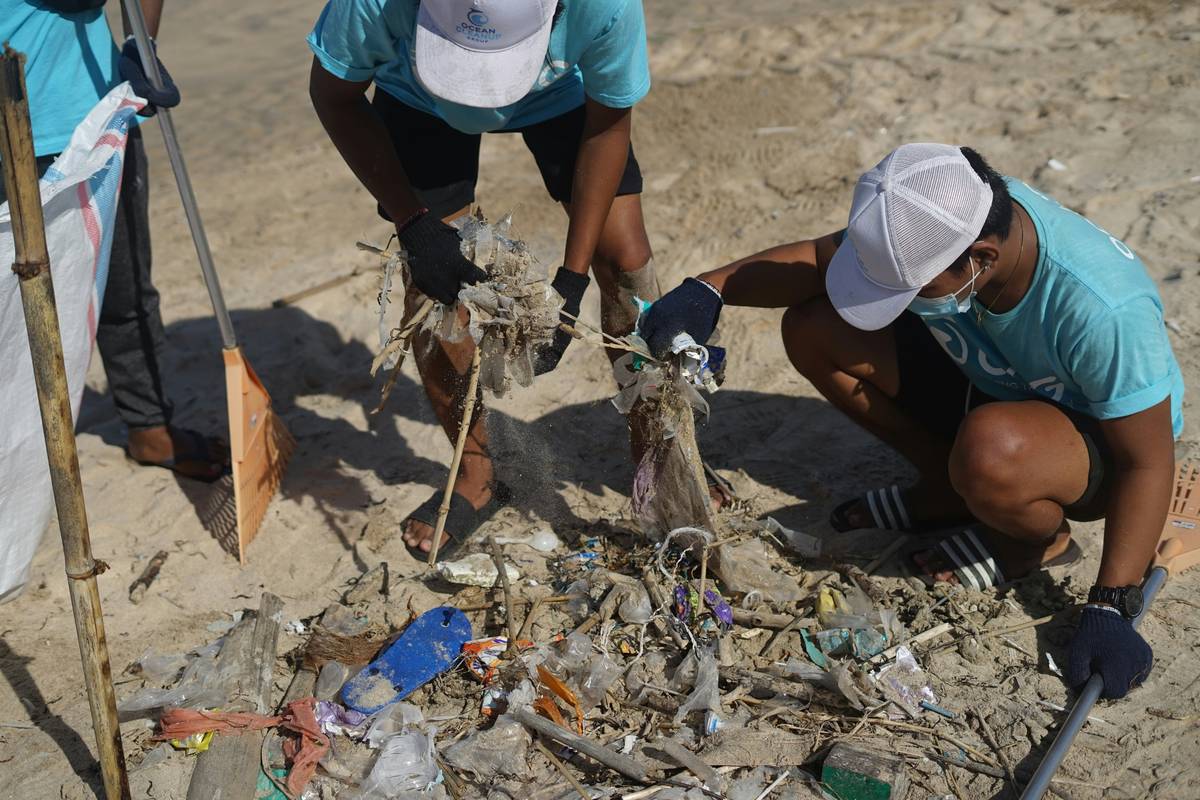 cleaning plastics on the beach