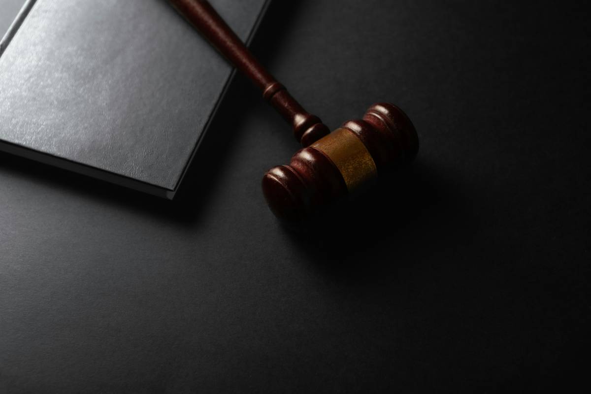 Judge gavel and book on black background. Law and justice concept