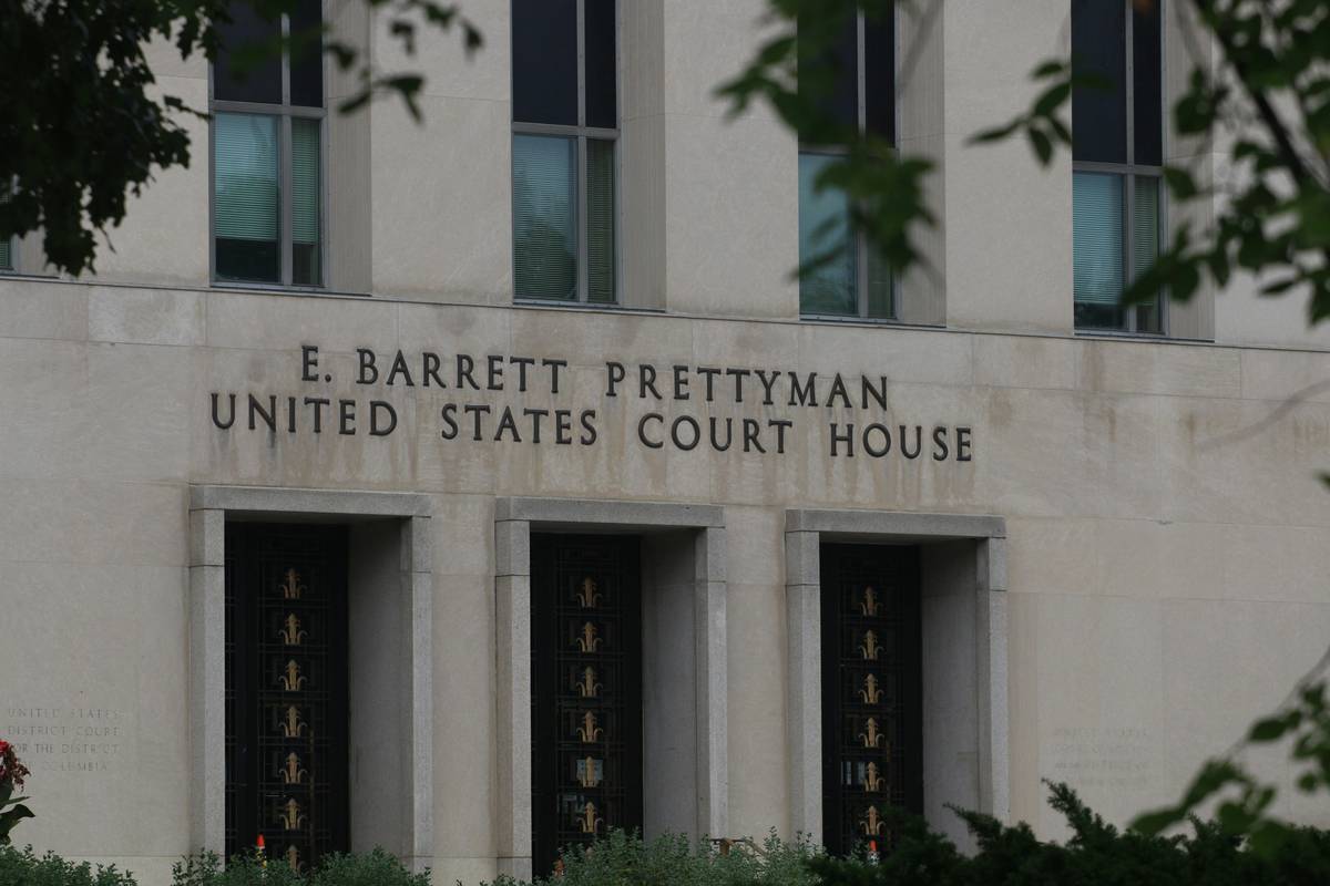 Pollution liability legal planning: contractor reviewing environmental risk assessment documents at job site