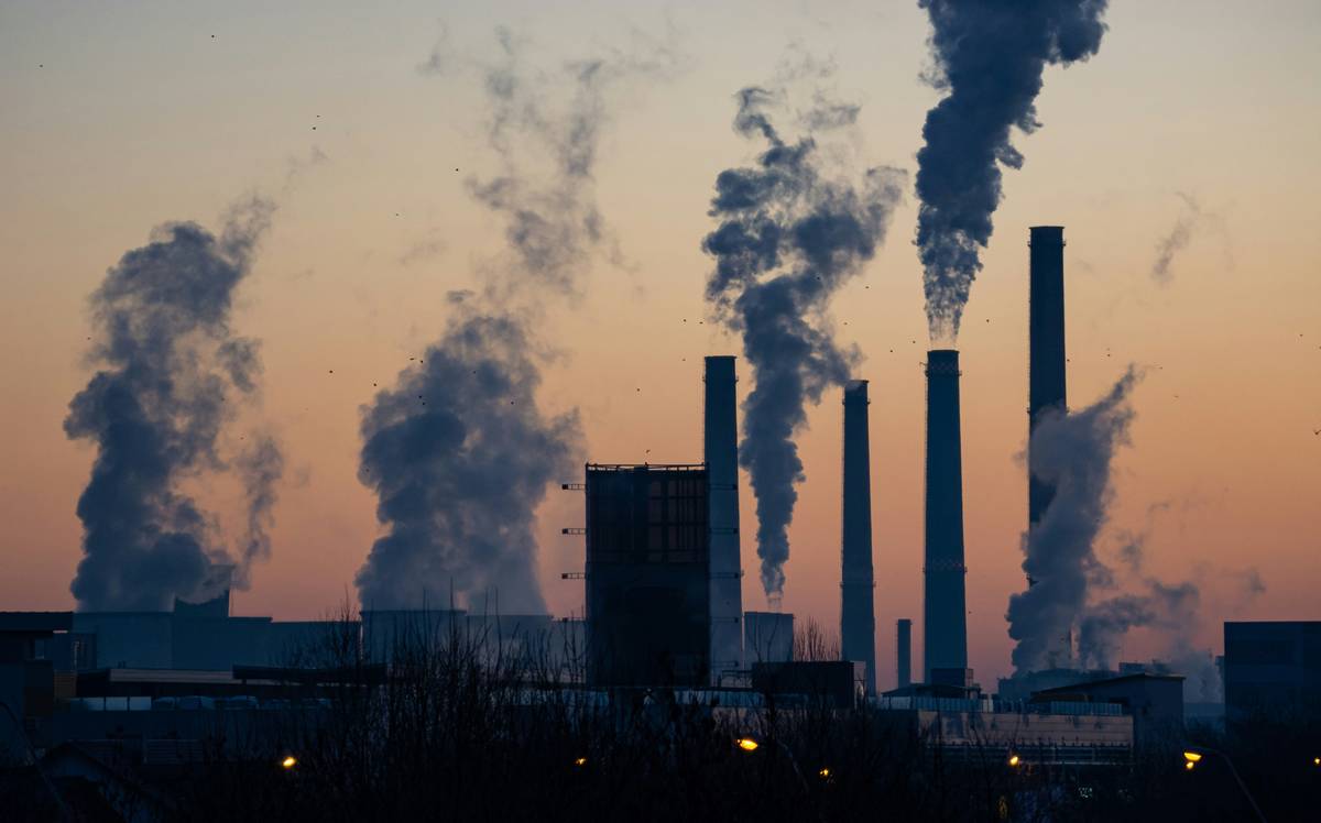 Hand holding digital checklist labeled 'pollution insurance tools' while reviewing site contamination report