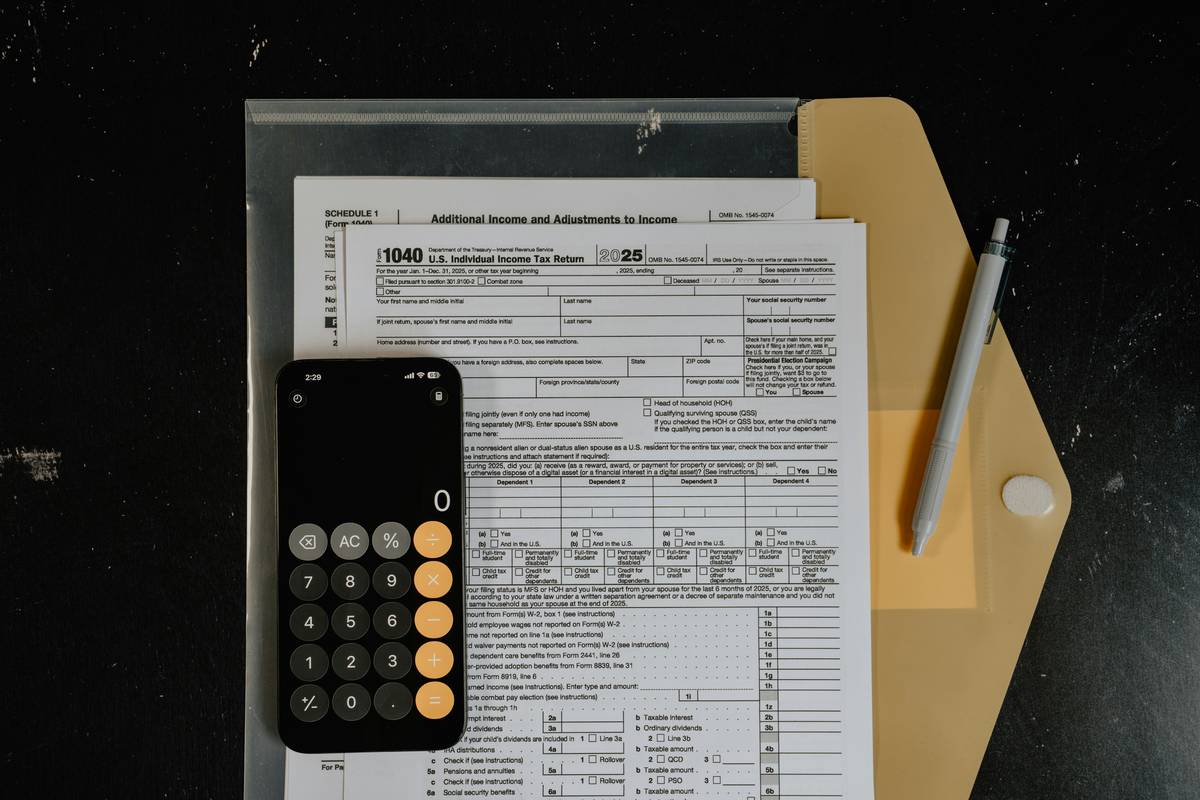 Cleanup insurance claim process: A close-up of a hands-on claims adjuster reviewing a Phase II ESA report beside a soil sample logbook